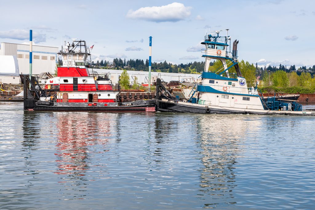 tugboats moored next to each other on columbia rive